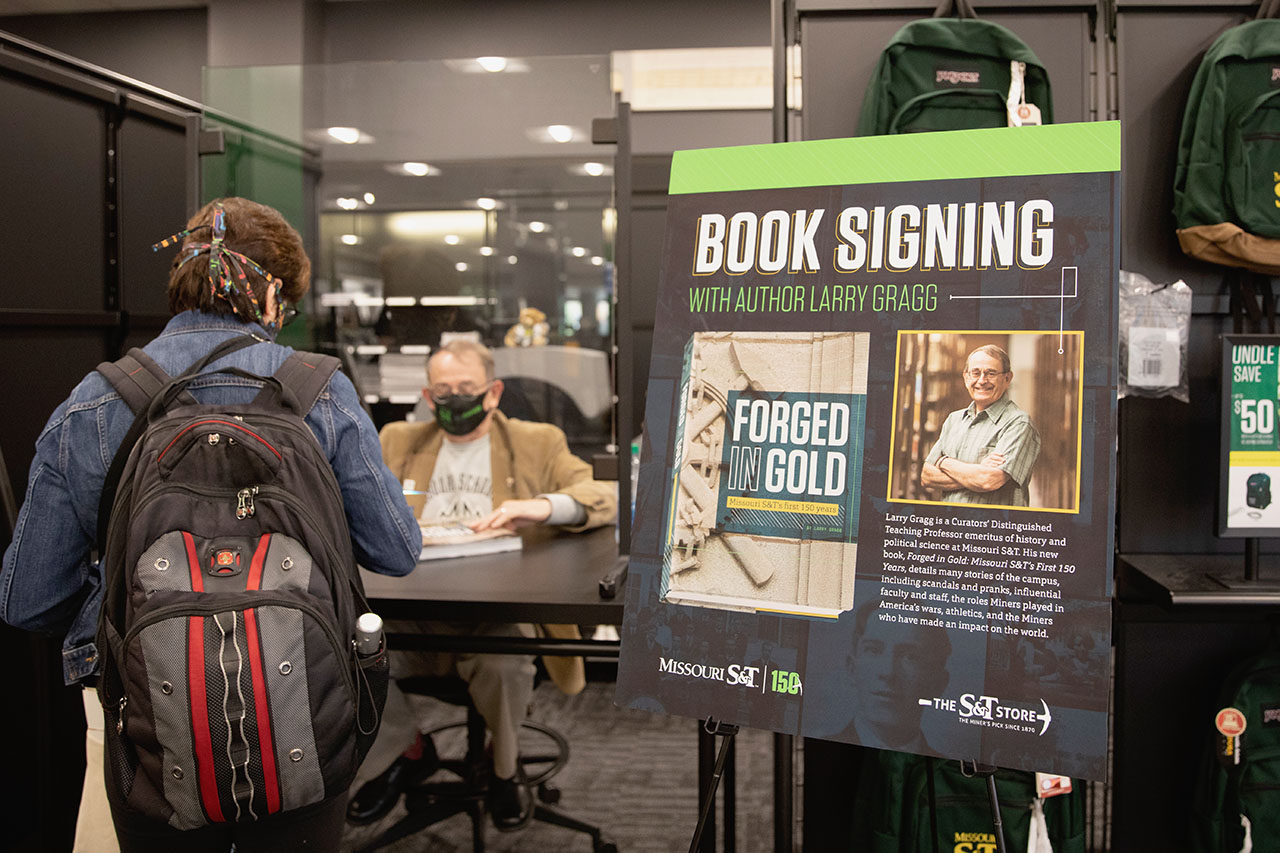 Student waits to have book signed by author.